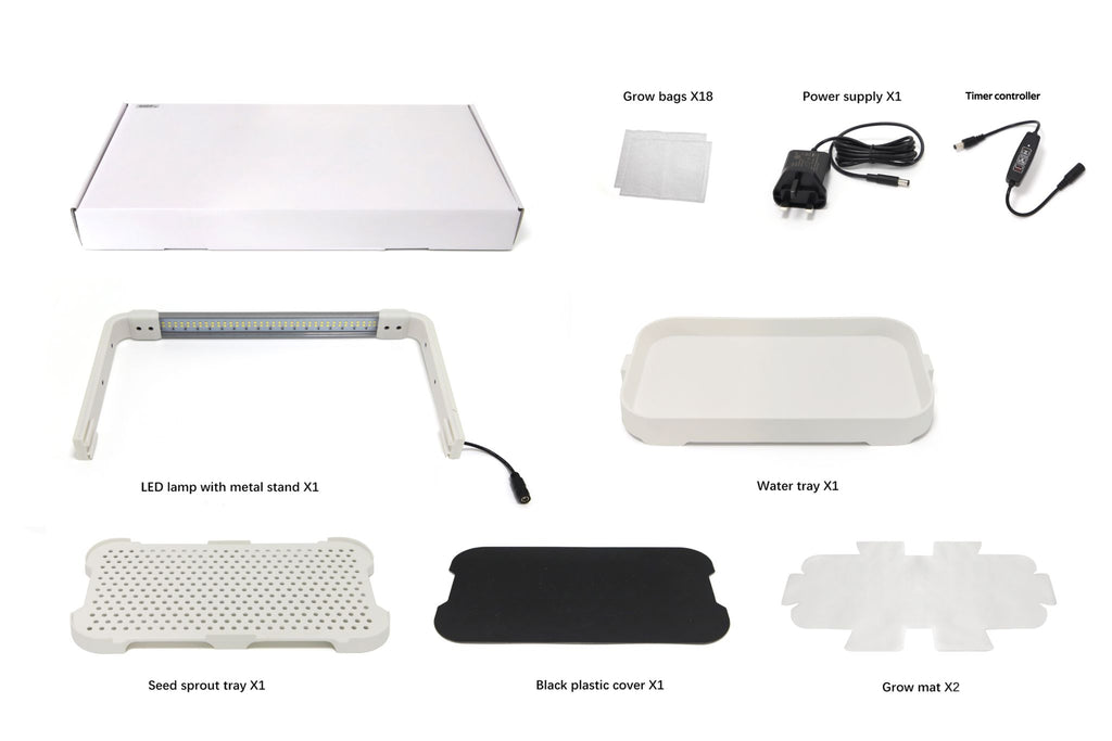 Box contents for the white microgreen garden system laid out in a grid. Includes power adapter, LED light in a plastic stand, grow mats, grow bags, handheld controller, water and sprout trays, and a black plastic cover.