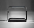Black microgreen garden system with a height-adjustable LED grow light used for indoor gardening.