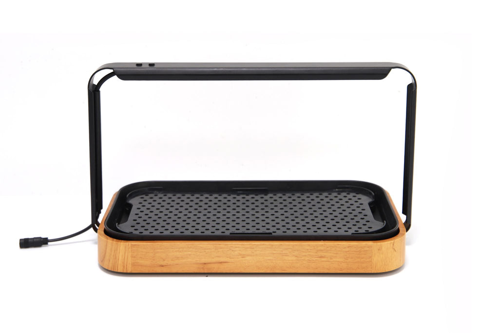 Premium microgreen garden system featuring a stylish bamboo base and integrated LED grow light for indoor gardening.