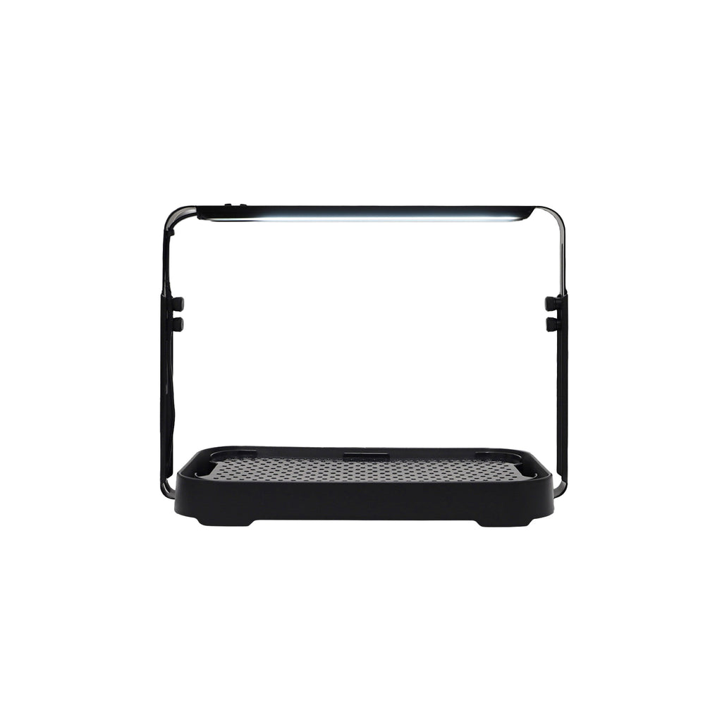 Black microgreen garden system with a height-adjustable LED grow light used for indoor gardening.